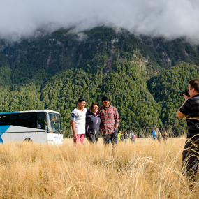 Family getting photo in front of Great Sights Bus