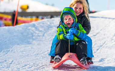 Kids Sledging at Coronet peak Ski Field, Queenstown