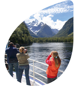 Tourists taking a picture on Milford Sound cruise