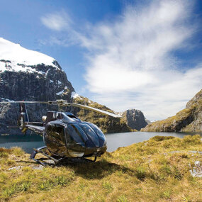 Luxury helicopter landing in Firodland National Park surrounded by lakes and mountains