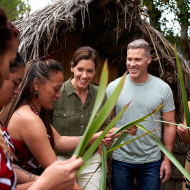 Visitors to Rotorua being shown how to weave