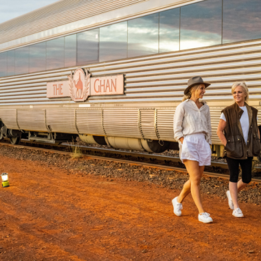 People walking in front of the Ghan