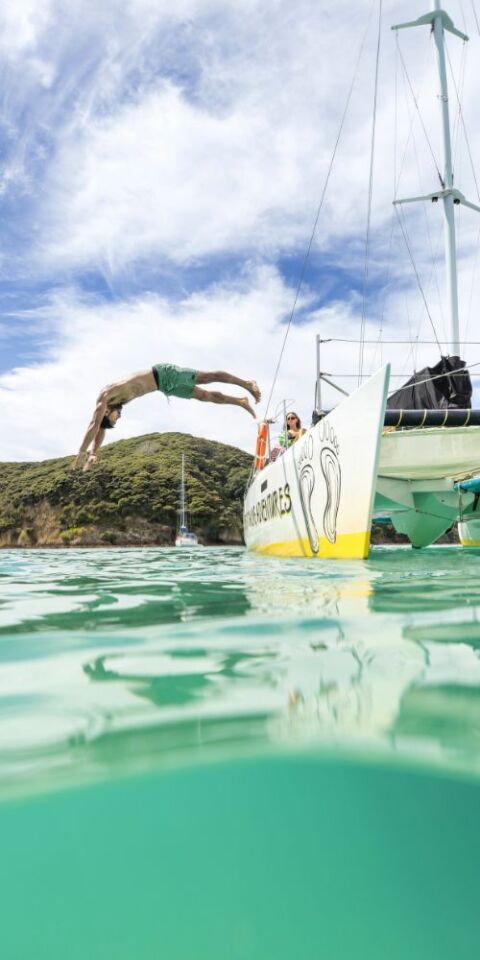 Man jumping off boat - credit to Miles Holden