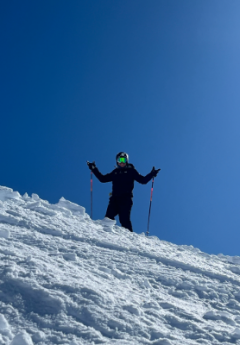 Skier with blue skies and snow on a mountain