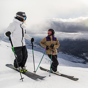 Two skiers on the slopes overlooking Cardrona