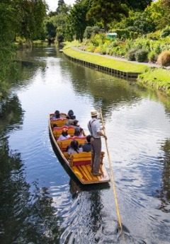 A punter guides a boat full of people down the Avon River.