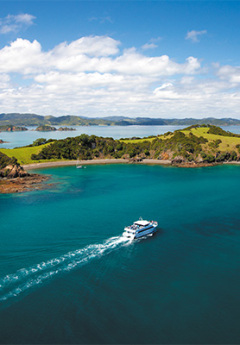 Aerial View of Bay of Islands and a boat heading towards an island