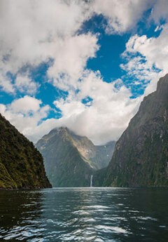 View of Milford Sound and towering mountains in Fiordland National Park