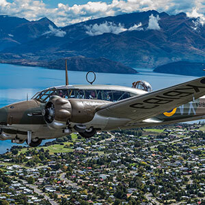 Image of a plane during Warbirds over Wanaka and mountains in the background