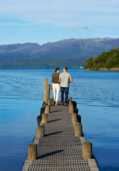 Couple looking out from lake Rotorua Pier