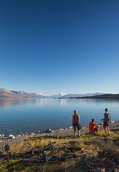 A group of travelers admiring Mount Cook over Lake Pukaki