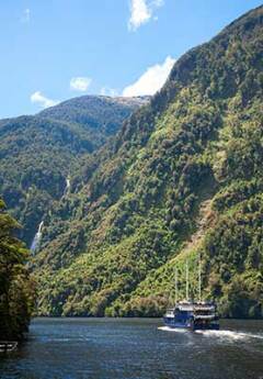 A boat cruising in Doubtful Sound