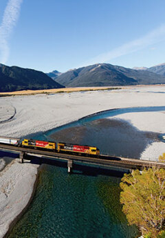 Tranzapine scenic train crossing the river on a sunny day