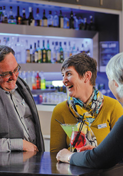 Grand Pacific travellers enjoying a drink at the hotel bar