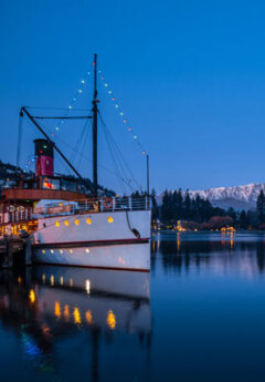 The TSS Earnslaw sits docked on Lake Wakatipu in Queenstown at nighttime