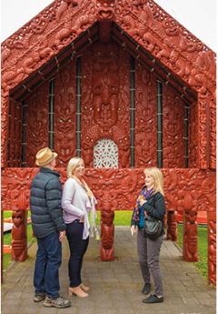 Travellers exploring Maori monument, New Zealand