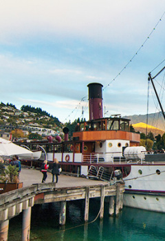 The TSS Earnslaw steamship docked at a pier in Queenstown on the  lake.