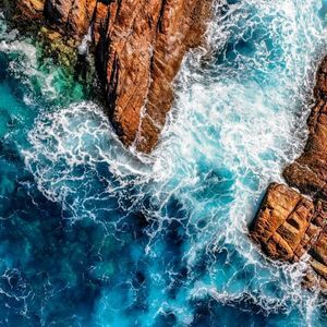 View of crystal clear waters and brown canal rocks in Yallingup
