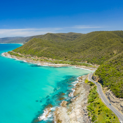 Turquoise water with road along the coast and rolling hills