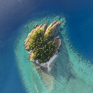 Aerial view over Arkhurst Island and the surrounding turquoise waters in the Whitsundays