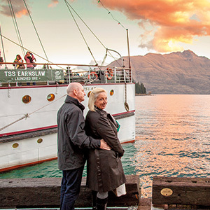 A couple enjoying sunset over Lake Wakatipu in Queenstown