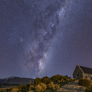 The Church of the Good Shepherd is in the bottom right frame, it is nighttime, and the Milky Way stretches across the sky.