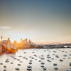 The port of Sydney at sunset with the Sydney Harbour Bridge seen in the background