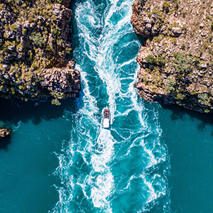 Aerial view of a boat cruising over the top of Horizontal Falls in the Kimberley