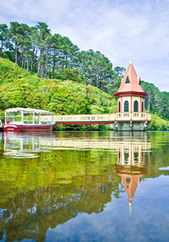 View over the water at Zealandia with boat and tower