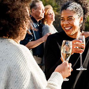 Two people enjoying a glass of wine at Freycinet