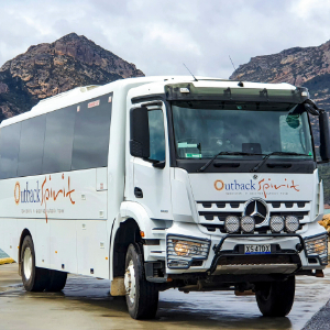 Outback Spirit Vehicle parked with mountains behind