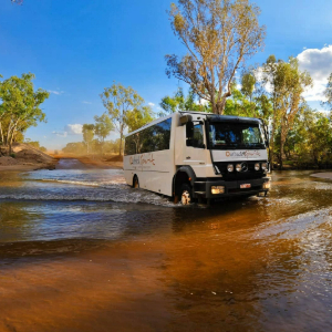 4WD coach travelling through large paddles