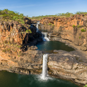 triple tower falls flowing down tall sand cliffs