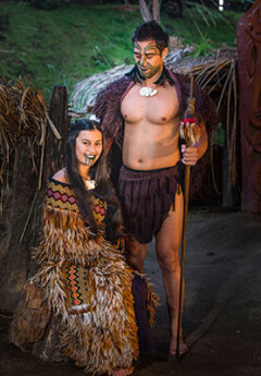 Maori man and woman in traditional clothes