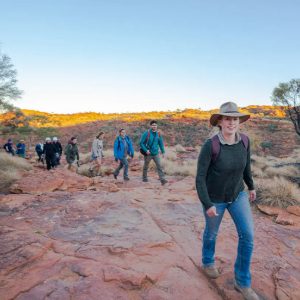 A guide leading a tour group through Uluru-Kata Tjuta National Park