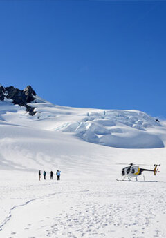 A group of travelers on Franz Josef Glacier during a helicopter landing