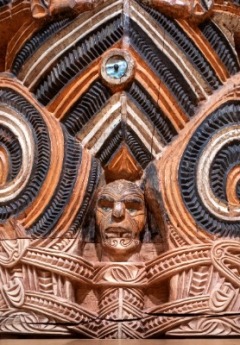 A close-up of a carved wooden Maori design with intricate patterns.