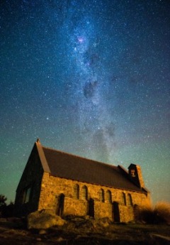 The historic Church of the Good Shepherd sits under a clear night sky full of stars.