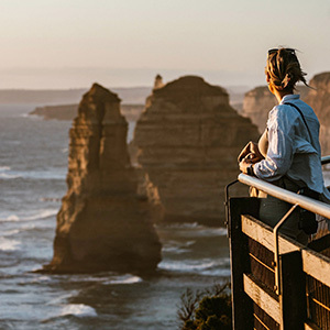 A person looks at the 12 Apostles shoreline