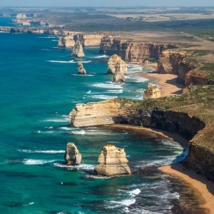 A stunning aerial view shows the iconic rock formations of the Twelve Apostles.