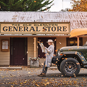 Lady looking at map with oranges leaves falling around her.