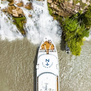 Luxury boat "True North" positioned directly under a waterfall.