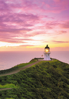 View of lighthouse in Cape Reinga and pink skies at dawn