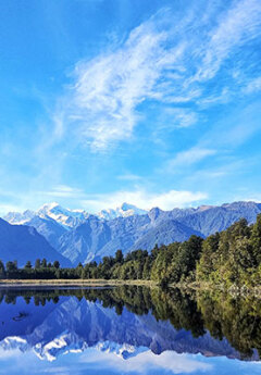 View of Lake Matherson and reflections of mountains in the lake