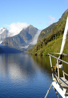 Cruising sounds in Fiordland and snow capped mountains at the backgrou d