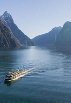 The Milford Haven floats on the water in Milford Sound