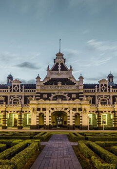 Historic Dunedin Railway Station and grey cloudy skies