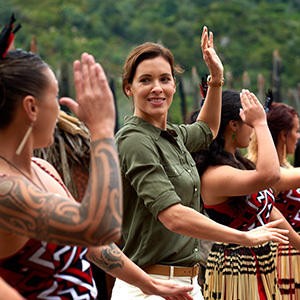 A lady learning about Maori culture and dance at Mitai Maori village