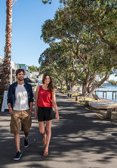 A couple walking in historic street of Russell in Bay of Islands