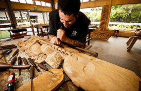 Carving wooden tiki at Te Puia